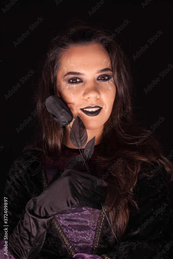 Witch with an evil face over black background . Halloween costume. Witch with an evil face over black background . Halloween costume.