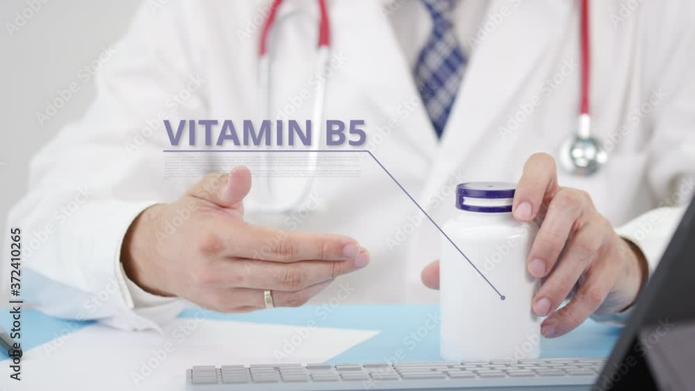 VITAMIN B5, a generic supplement, in the bottle in doctor's hand VITAMIN B5, a generic supplement, in the bottle in doctor's hand