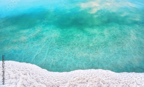 Фотография Shore of Dead sea in Ein Bokek, Israel, white salt crystals outside and at the b