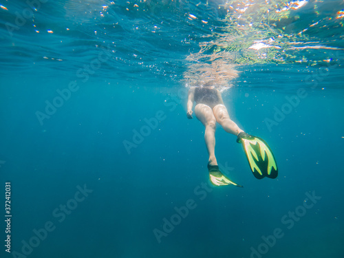 woman in flipper view underwater beach vacation