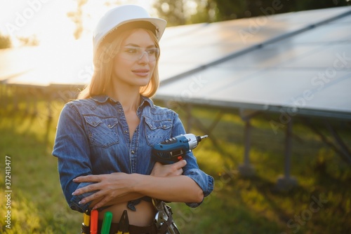 Beautiful woman working on installing solar panels. Solar electricity concept.