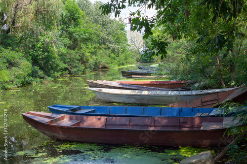 Old wooden fishing boats on a pond. Traditional small fishing boats on river bank in Serbia.