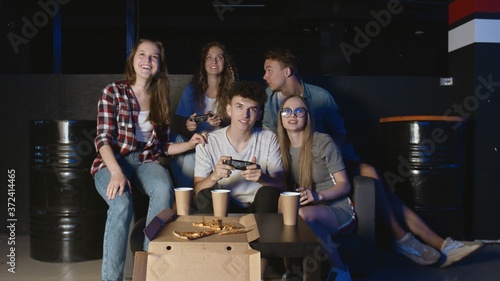 Young happy man completes hard level in video game. Having fun with friends.