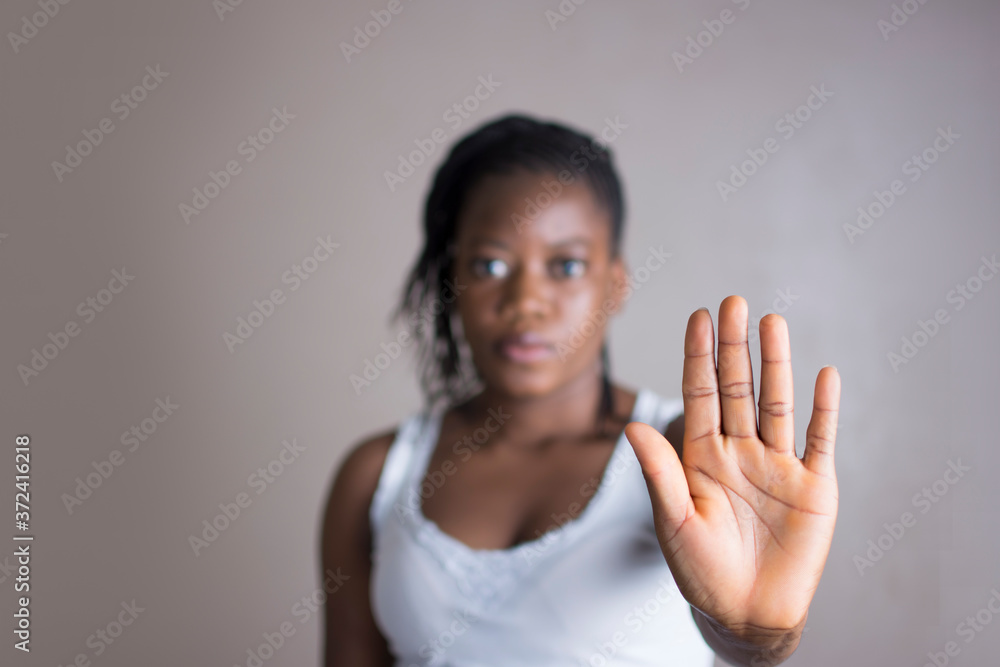 Hand in focus, young woman making stop gesture. Hand in focus, young woman making stop gesture.
