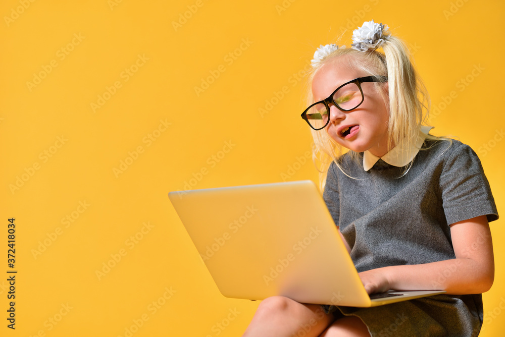 Funny girl child communicates on a social network and shows tongue Funny girl child communicates on a social network and shows tongue