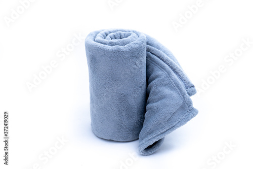Rolled up grey coral fleece throw isolated on white background