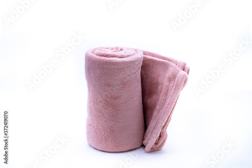 Rolled up red coral fleece throw isolated on white background