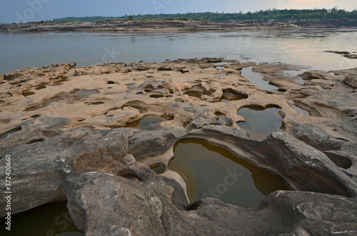 Small ponds on the rock after ebb tide of the river