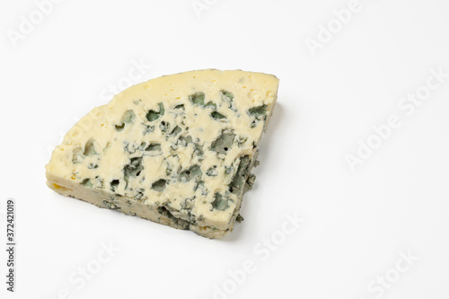 Triangular piece of blue cheese. Isolated on a white background.