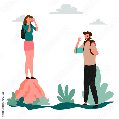 A woman stands on a large rock and photographs a man. Forest road, hiking, hike, tourism. Local tourism. Travelers hiking adventure, orienteering outdoor vector