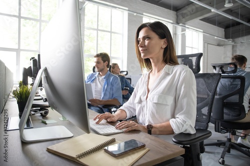 Woman working on computer at modern office