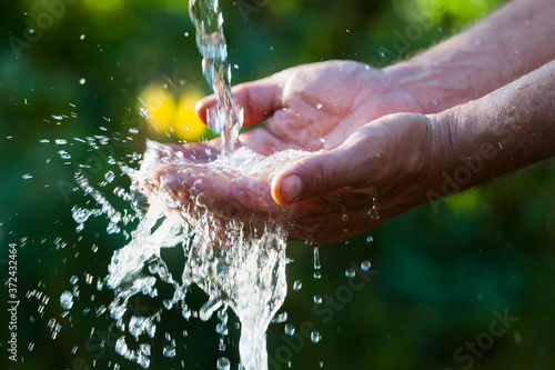 Canvas Print Muslim man washes his hands before prayer ritual cleansing.