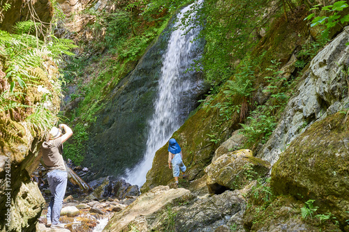 Hiking with the family on the trail "Höllsteig" in the canyon "Ravennaschlucht" in the Black Forest in Germany