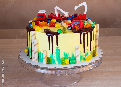 Children's colorful fondant birthday cake decorated with little cars