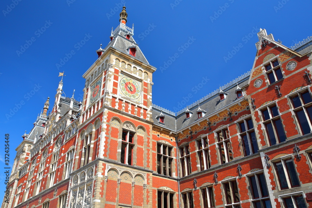 Fototapeta premium Architectural details of the colorful Amsterdam Central station, designed by Dutch architect Pierre Cuypers and opened in 1889, Amsterdam, Netherlands