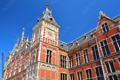 Architectural details of the colorful Amsterdam Central station, designed by Dutch architect Pierre Cuypers and opened in 1889, Amsterdam, Netherlands