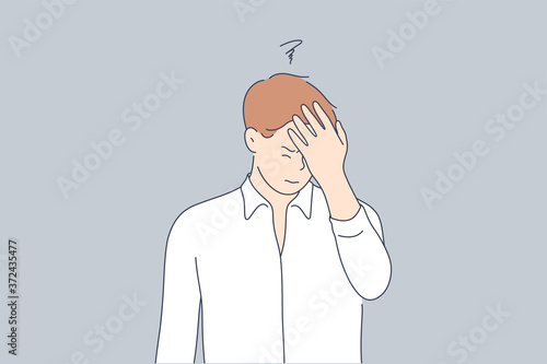 Emotion, face, expression, frustration, despair, stupidity, remember concept. Young unhappy sad man guy character standng with hand on head for mistake or remembering error. Headache or bad memory.