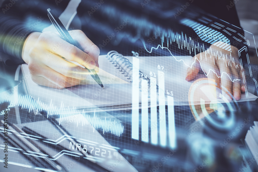 Tech theme hologram over woman's hands taking notes background. Concept of hightech. Double exposure Tech theme hologram over woman's hands taking notes background. Concept of hightech. Double exposure