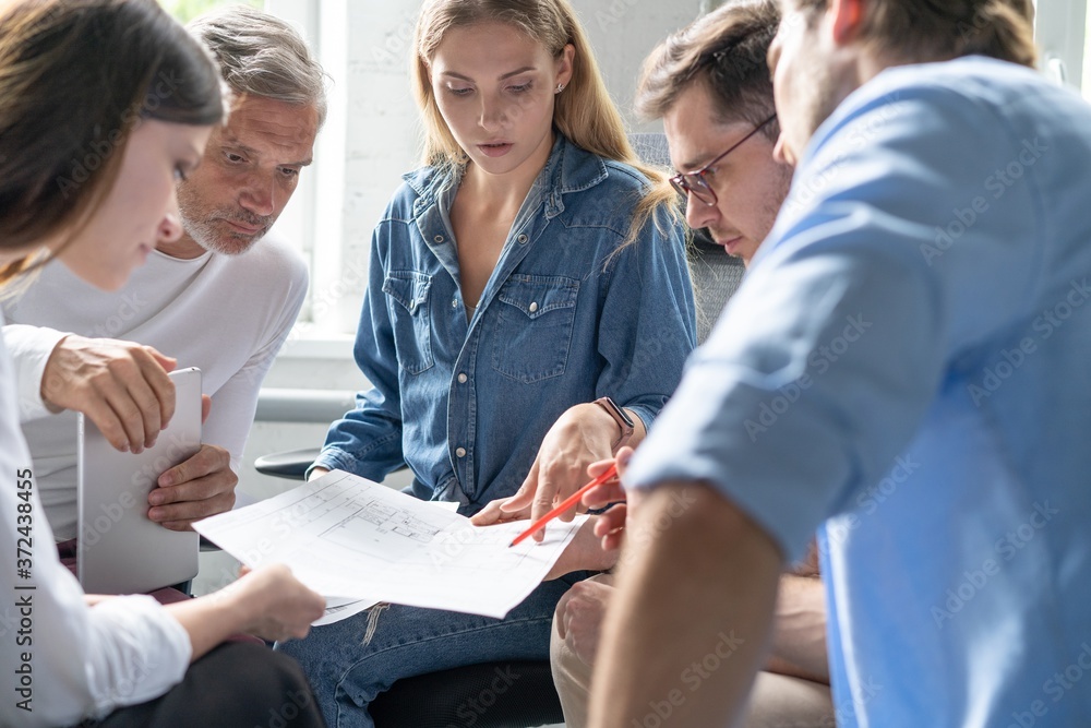 Shot of a group of young business professionals having a meeting. Diverse group of young designers smiling during a meeting at the office. Shot of a group of young business professionals having a meeting. Diverse group of young designers smiling during a meeting at the office.