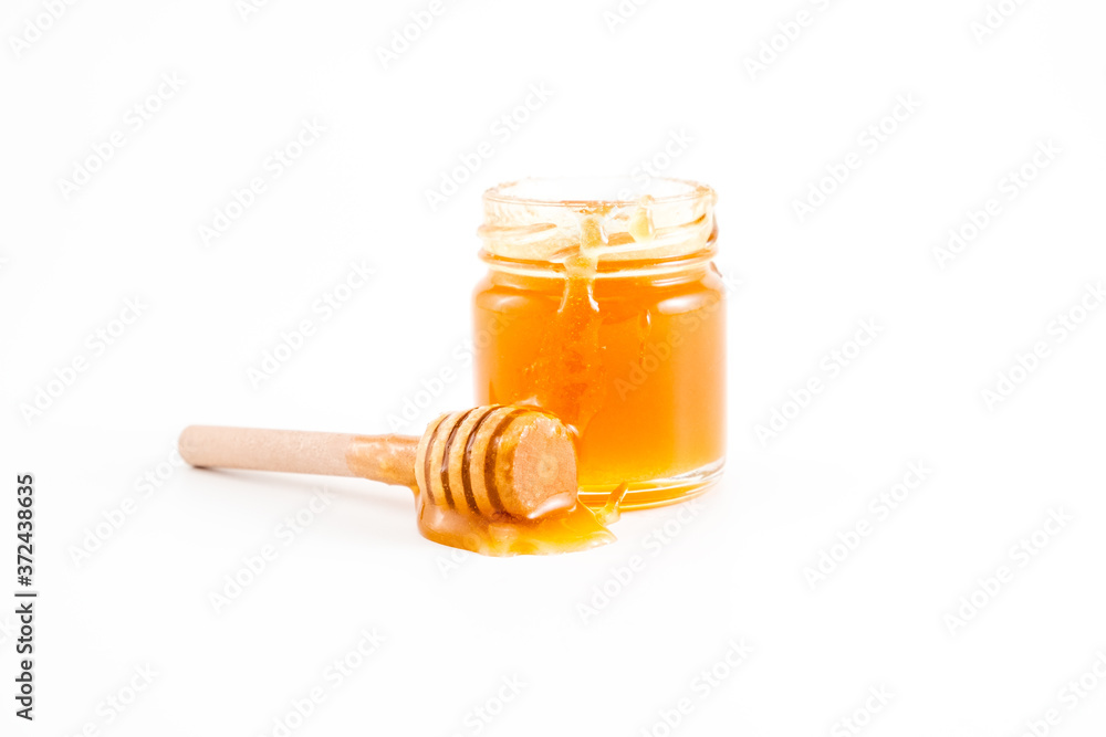 honey and honey in jar on white background honey and honey in jar on white background