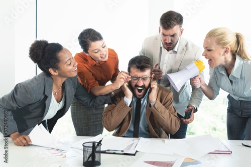Colleagues criticizing boss for his wrong decision making photo