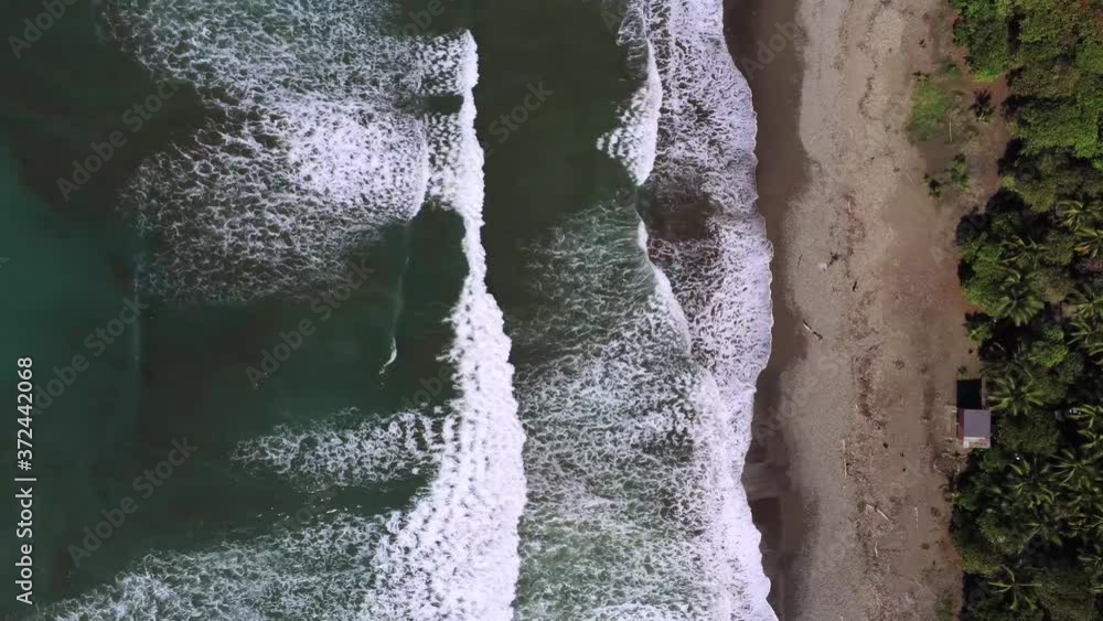 Aerial static top down drone time lapse, waves break on tropical beach Aerial static top down drone time lapse, waves break on tropical beach