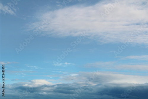 Fototapeta Naklejka Na Ścianę i Meble -  Blue bright sky with clouds, natural beautiful background. Soft daylight. Stock photo with empty space for text and design. 