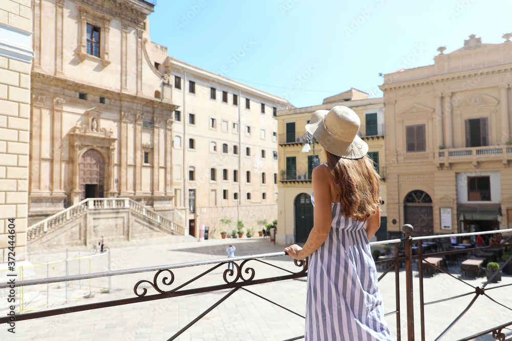 Young tourist woman visiting the old town of Palermo in Sicily, Italy