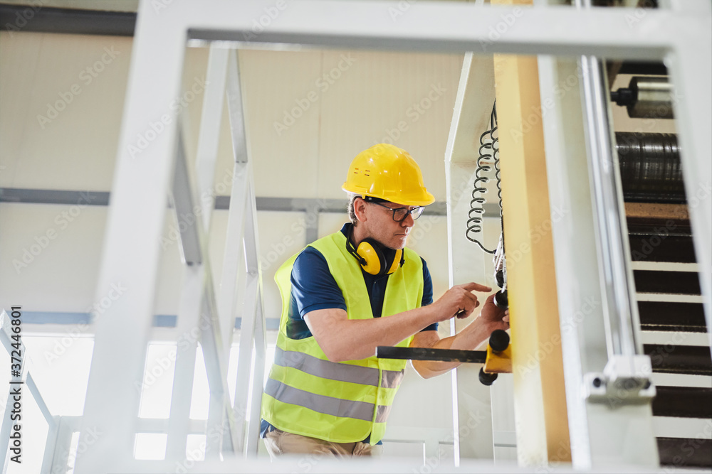 Portrait of a technician or engineer checking and adjusting equipment in industrial site factory or utility
Portrait of a technician or engineer checking and adjusting equipment in industrial site factory or utility