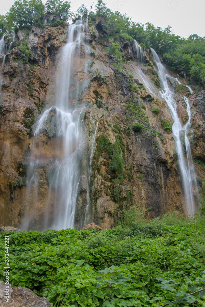 A long exposure of a large waterfall flowing at Plitvice Lakes, Croatia