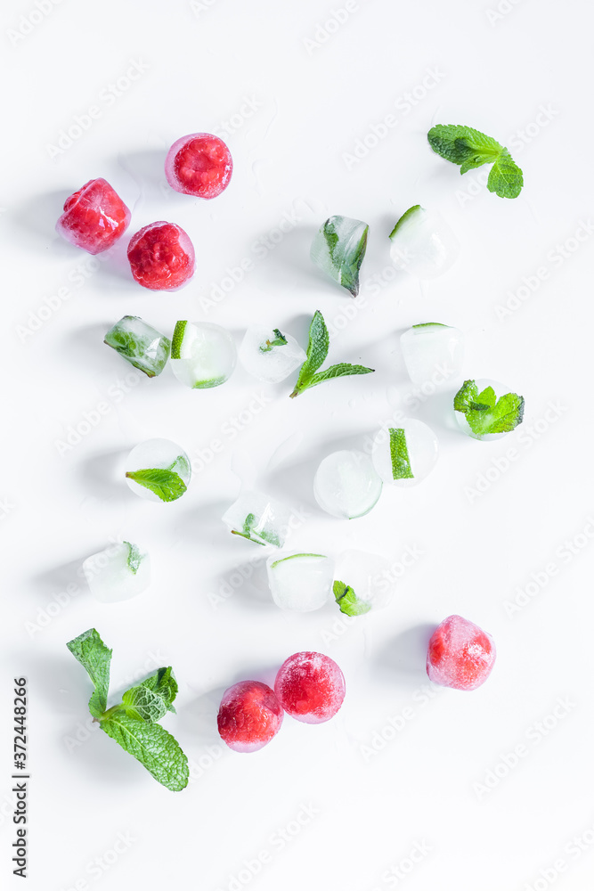 Berries frozen in ice cubes background flat lay Berries frozen in ice cubes background flat lay