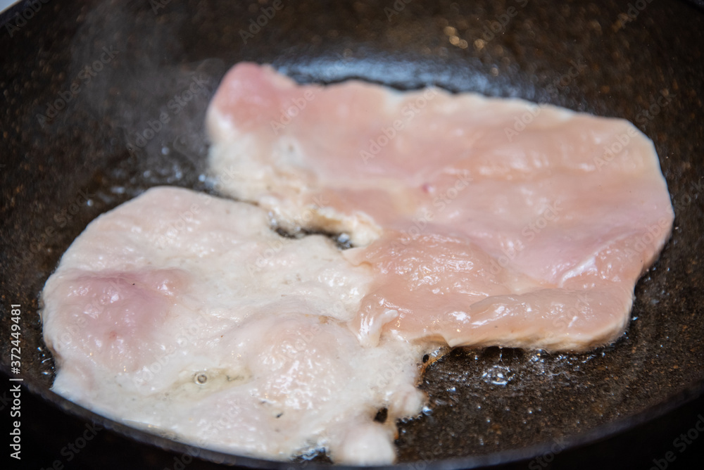 Chicken fillet fried in oil in a pan Chicken fillet fried in oil in a pan