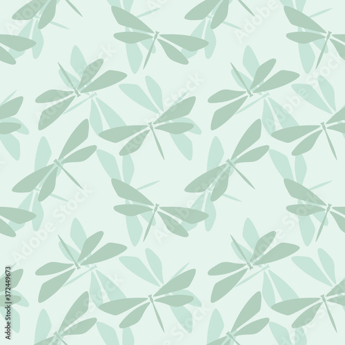 Seamless repeat pattern with dragonfly silhouettes. Random dragonflies vector background. Nature theme green background design perfect for fabric or wrapping paper.