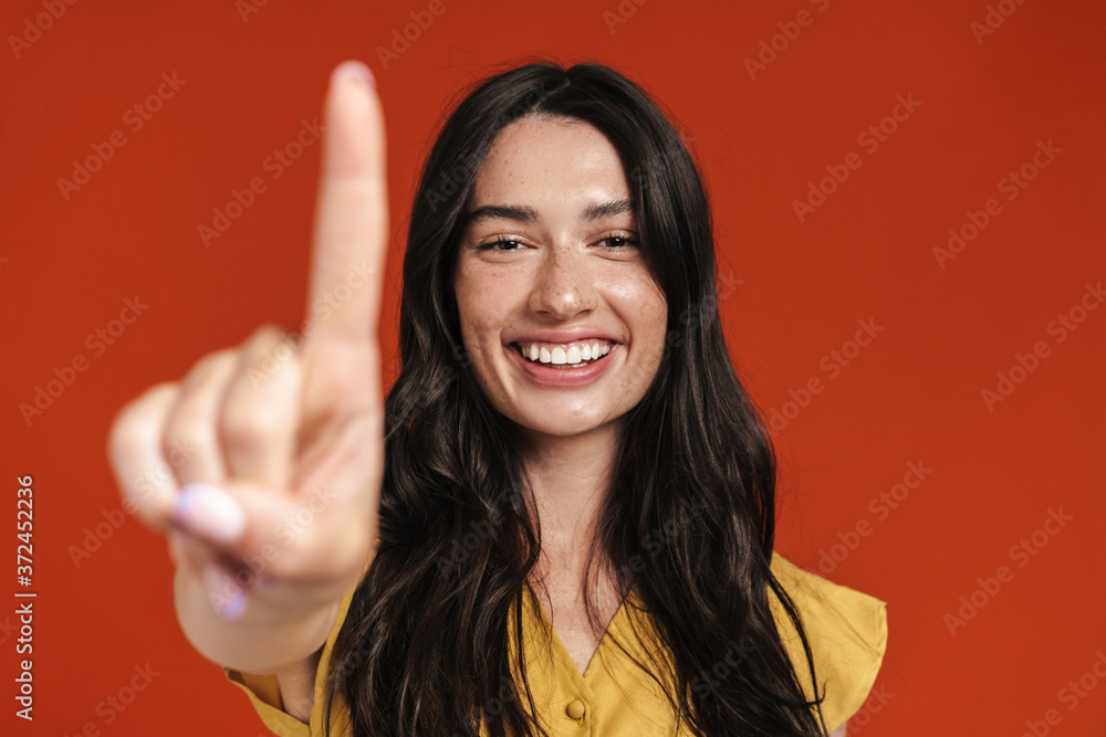 Image of caucasian smiling woman showing finger at camera Image of caucasian smiling woman showing finger at camera