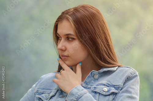 Portrait of a young beautiful woman with a pensive facial expression.
