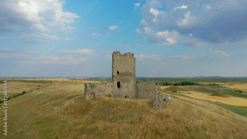 Close Up View Of La Torresaviñan Castle Atop On The High Hill Surrounded By Fields And Meadow In La Torresaviñán, Spain. - aerial (backward) Close Up View Of La Torresaviñan Castle Atop On The High Hill Surrounded By Fields And Meadow In La Torresaviñán, Spain. - aerial (backward)