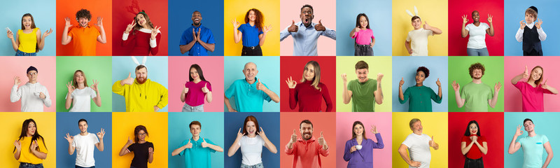 Collage of portraits of 28 young emotional people on multicolored background. Concept of human emotions, facial expression, sales. Look astonished, celebrating, nice sign, thumbs up, winners.