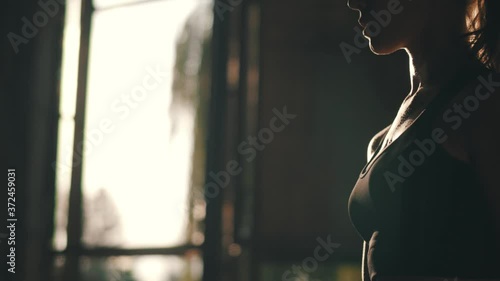 Strong Athletic Woman Training with Dumbbells, Pumping Arms Muscles. Professional Bodybuilder Doing Total Body Workout with Heavy Weight.