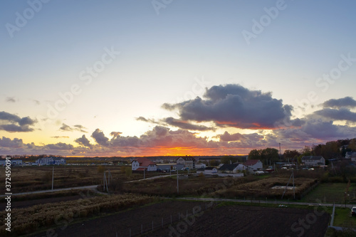 Sunset over the fields. Village in the sun.