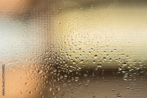 Drops of water slipping on a glass