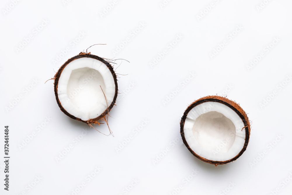 Two halves of raw coconut on gray background. Healthy healthy food concept