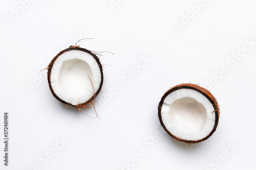 Two halves of raw coconut on gray background. Healthy healthy food concept
