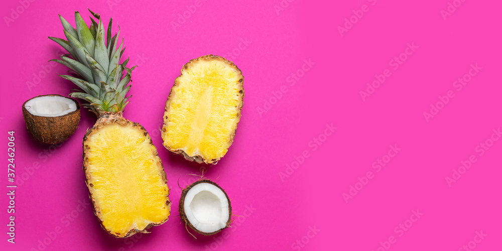 Top view of two halves coconut pineapple on pink background. Flat lay, copy space. Healthy healthy food concept Top view of two halves coconut pineapple on pink background. Flat lay, copy space. Healthy healthy food concept