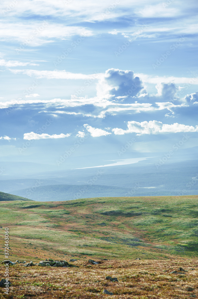 Scenic view of beautiful landscape with tundra hills and sky clouds