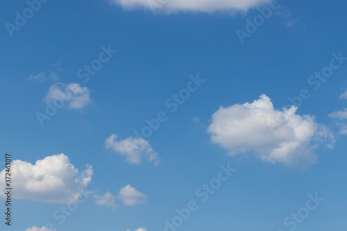 Blue sky in sunny weather. There are white clouds in the sky.