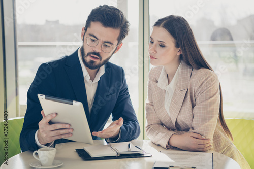 Close-up portrait of his he her she two nice stylish focused people agent broker ceo boss chief reading stock exchange market finance news at light white workplace workstation