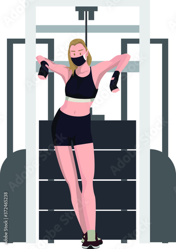 A woman with medical mask standing in front of fitness equipment