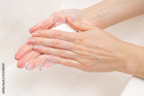 antibacterial soap in the hands. soapy hands. Wash hands with soap and water. Coronavirus Prevention, COVID-19, The concept of virus protection during the coronavirus epidemic.