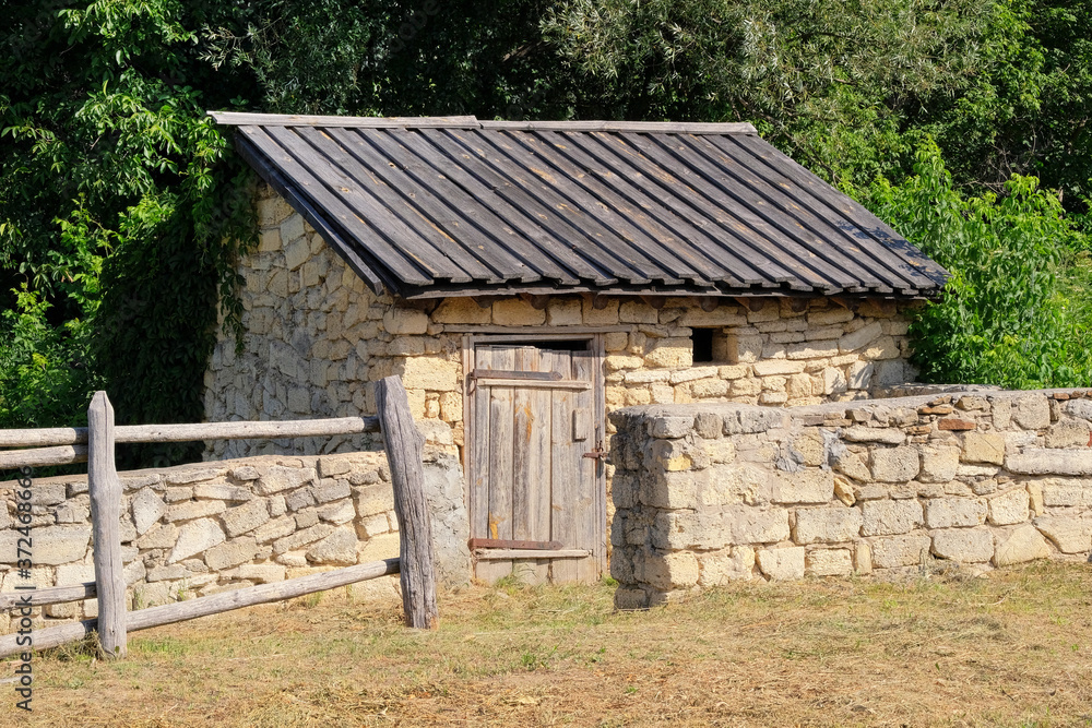 Old rural house with wooden roof and stone walls. European village is preserving rustic traditions and culture. Old rural house with wooden roof and stone walls. European village is preserving rustic traditions and culture.