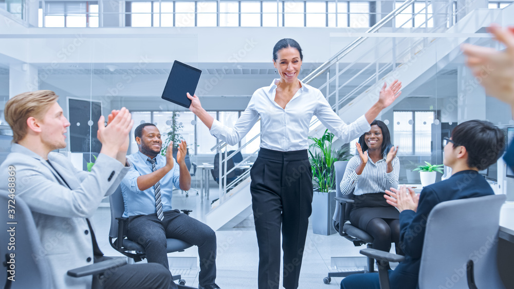 Beautiful Happy Business Woman Manager is Being Cheered and Celebrated by Her Colleagues due to Success. Diverse and Motivated Business People Work on Computers in Modern Open Office. Beautiful Happy Business Woman Manager is Being Cheered and Celebrated by Her Colleagues due to Success. Diverse and Motivated Business People Work on Computers in Modern Open Office.